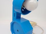 an image of a blue lamp that is on a white table