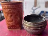 two cups sitting on a table next to each other