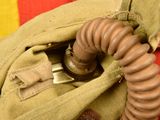 an image of a gas mask in the pocket of a bag