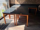 a table and chairs in a room with a large window