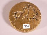 a gold plate with a picture of a man and a woman on it