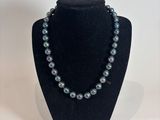a close up of a necklace on a mannequin display