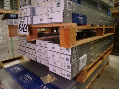 a large stack of boxes on a pallet in a warehouse