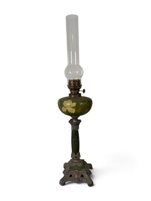 une lampe à l'ancienne surmontée d'un abat-jour en verre