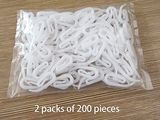 two packs of 200 pieces of white string on a table