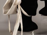two mannequin heads and a hat on display on a table