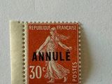 an orange stamp with a woman on it sitting on top of a white surface