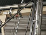 a metal structure with pipes attached to the side of it