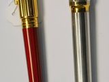 two pens sitting next to each other on a table