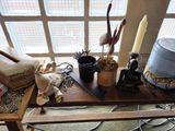 a wooden tray with a candle, a candle holder, and other items on it