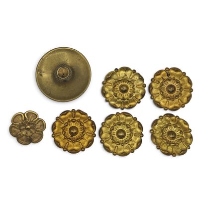 a close up of a bunch of metal buttons on a white surface