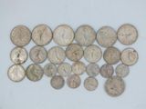 a close up of a pile of silver coins on a white surface