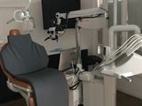 a dentist ' s chair in the corner of the room