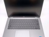 an open laptop computer sitting on top of a white table