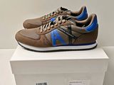 men ' s brown and blue sneakers on display on a white box