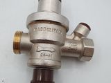 a close up of a metal pressurer on a white surface
