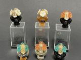 four glass vases with flowers in them sitting on a table