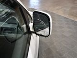 a car that has a broken mirror on the side of it