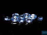 a bunch of blue sapphires on a black surface