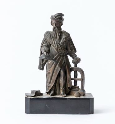 a statue of a man with a hat and a cane