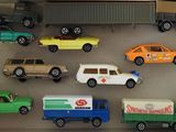 many toy cars and trucks in a display case