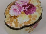 a heart shaped box with flowers painted on it