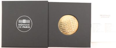 two black boxes with a gold coin inside of them on a white surface