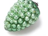 green glass christmas ornament with a bunch of green berries on it
