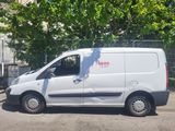a white van that is parked on the side of the street