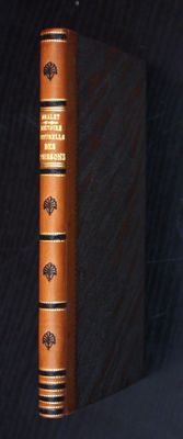 an old book sitting on top of a black table next to a black wall
