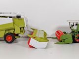 two toy tractors that are sitting next to each other