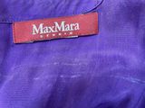 the label of a purple jacket is on the back of the jacket