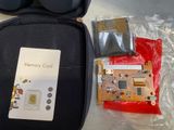 a memory card in a case next to a pair of glasses