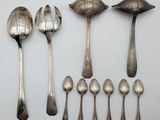 several spoons and spoon spoons are lined up on a white surface