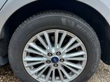 a close up of a car tire on a gravel road