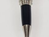 a pen that is sitting on a white surface