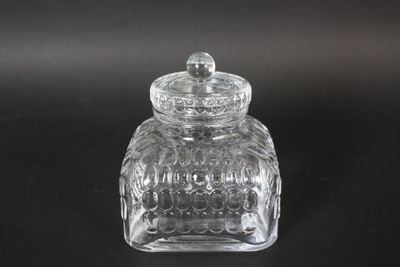 clear glass jar with a lid on a black surface