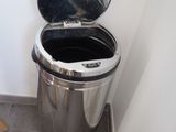 a trash can with a mirror on the top of it