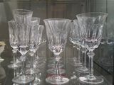 several empty wine glasses on a glass table in a glass case