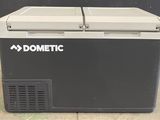 the dometic cooler is sitting on the ground outside