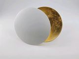 a white ball with a gold half on it