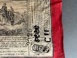 a red handkerchief with a picture of a man riding a horse