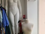 a mannequin in the corner of a room next to a window