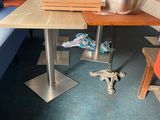 a table with a bowl on it in the corner of a room