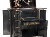 a black cabinet with a mirror on top of it
