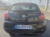 a black car that is parked on the side of the road