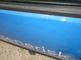 a close up of a blue car door with a sticker on it