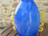 a large blue vase sitting on a wooden table