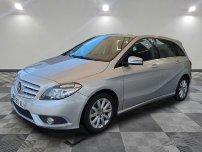 the mercedes b - class is parked on a checkered floor