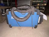 a machine that is sitting on the floor with a hose